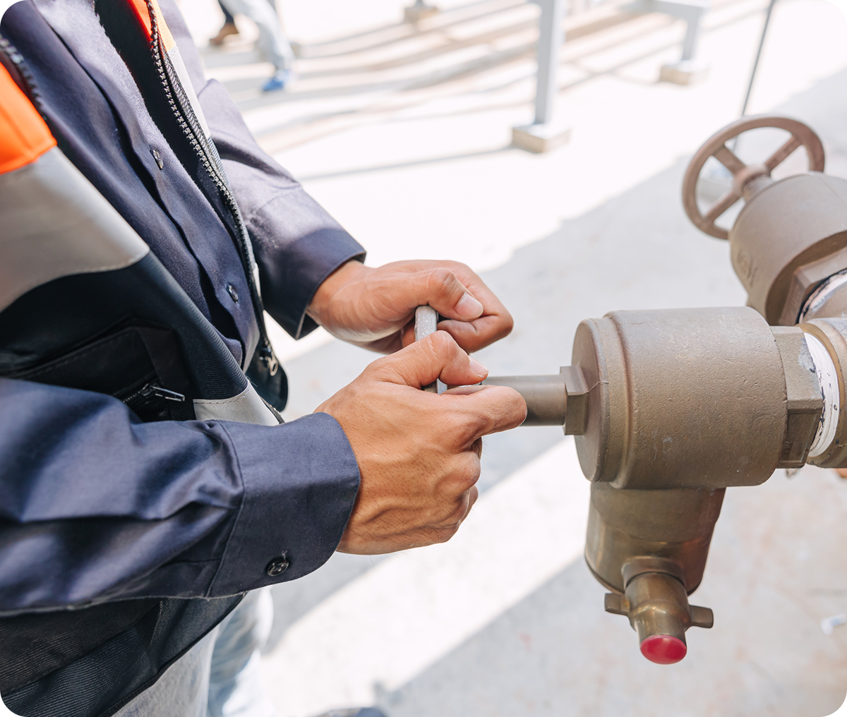 Technician adjusting machinery valve