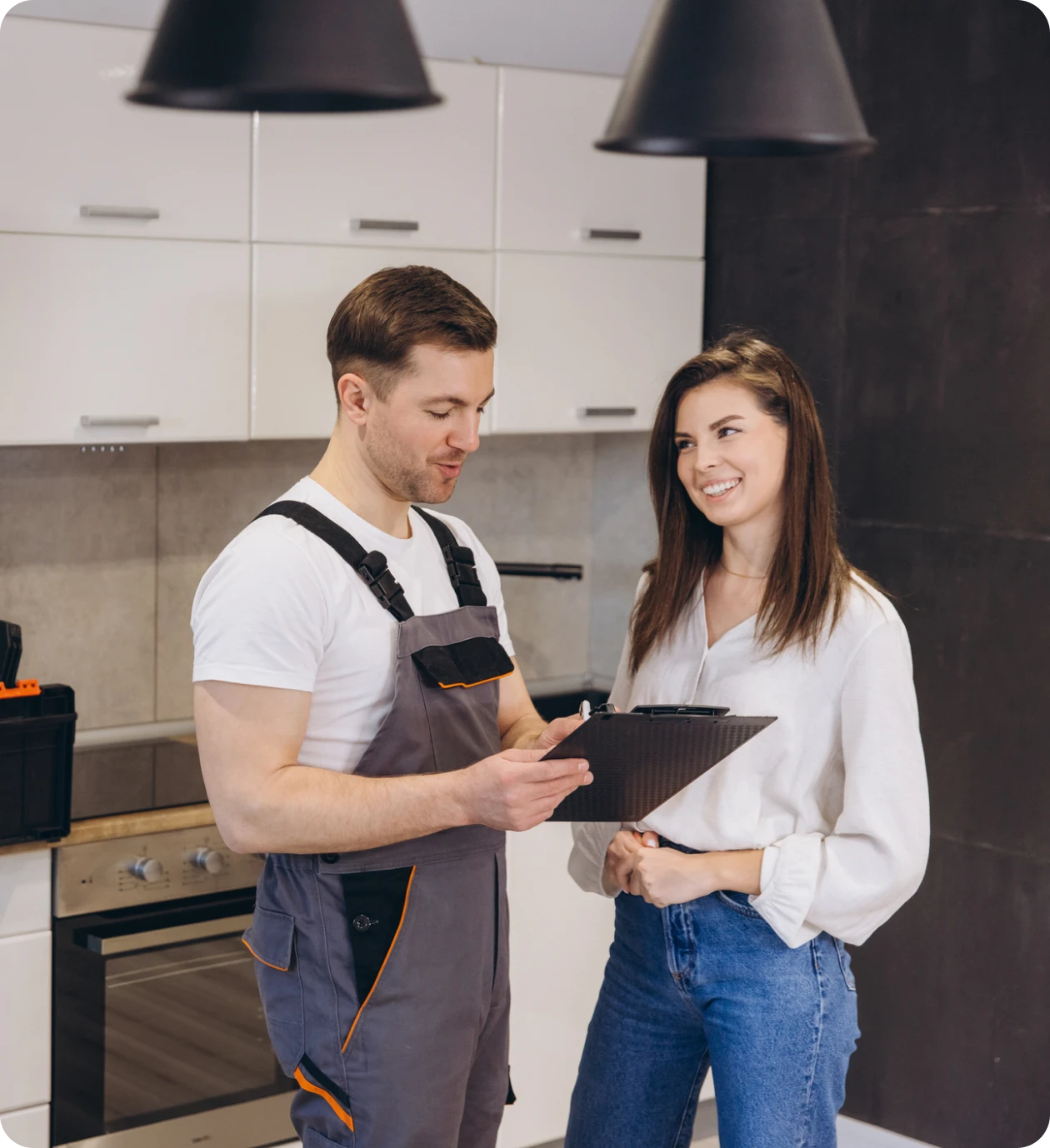Couple reviewing repair details in kitchen